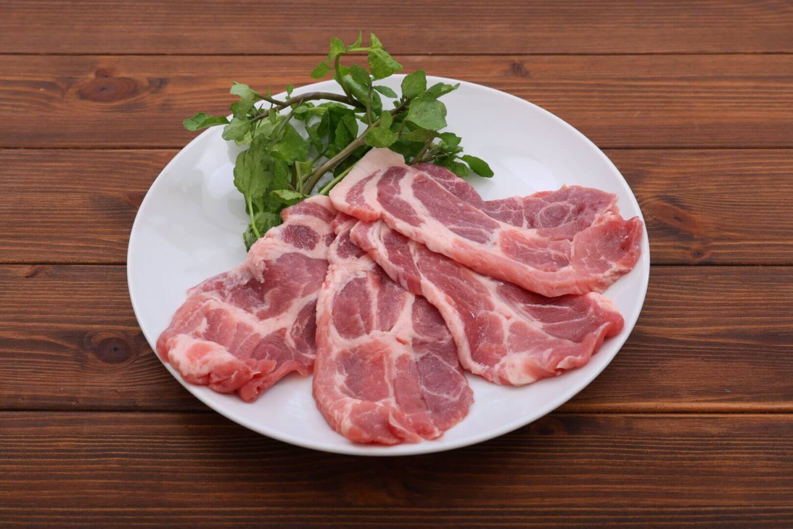 Raw pork slices on a plate
