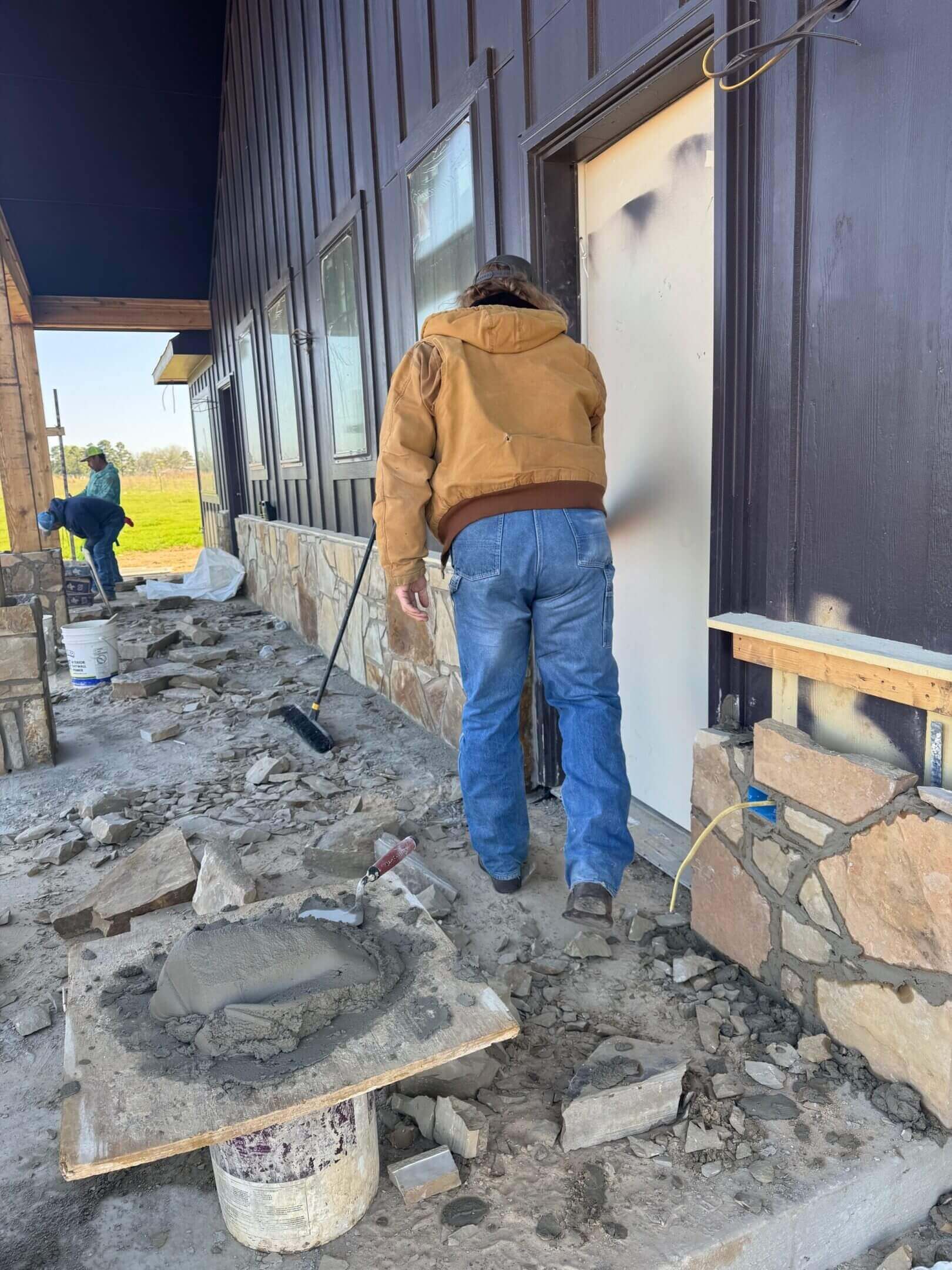 Workers installing stone facade outside building