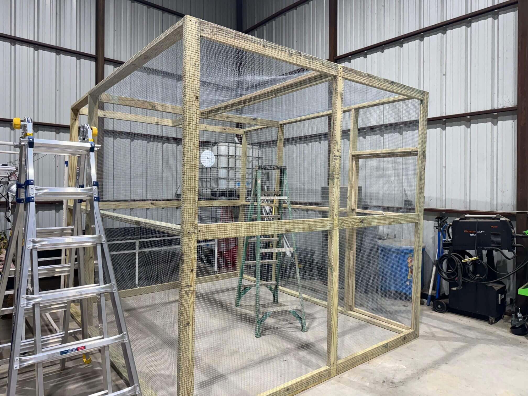 Wooden framed wire mesh enclosure in workshop